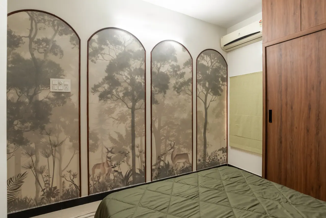 Bedroom feature wall of four arched panels with a misty forest and deer mural, beside an olive bed and wood wardrobe